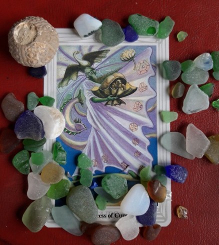 Thoth Princess of Cups with beach glass and a sea fossil.