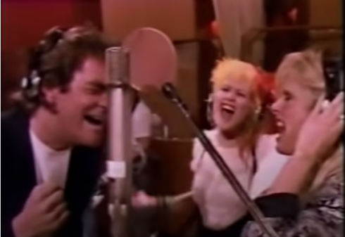 Huey Lewis, Cindy Lauper and Kim Carnes belting one out for the people.